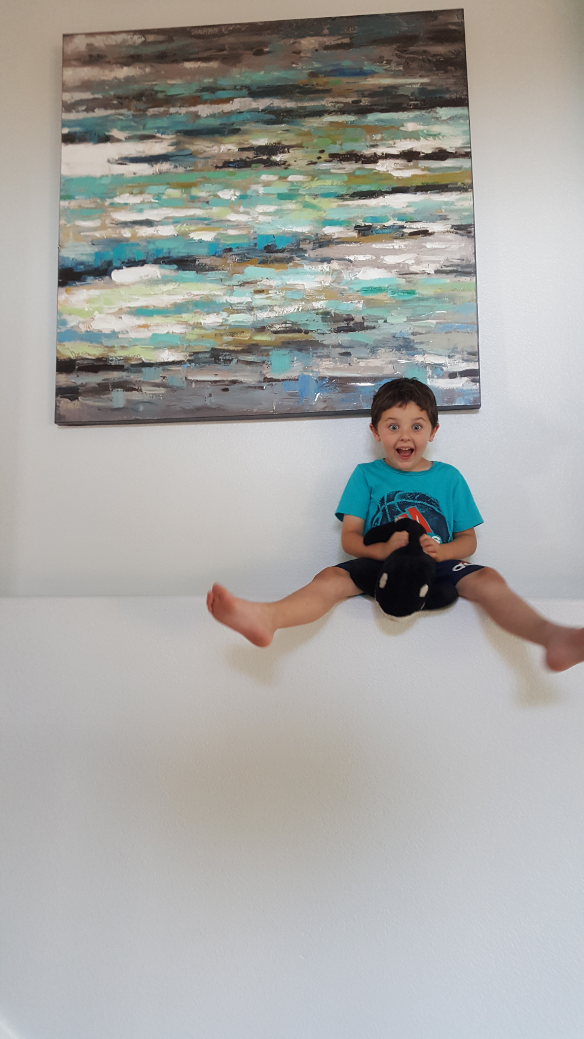 A joyful family moment at home, beneath a colorful painting