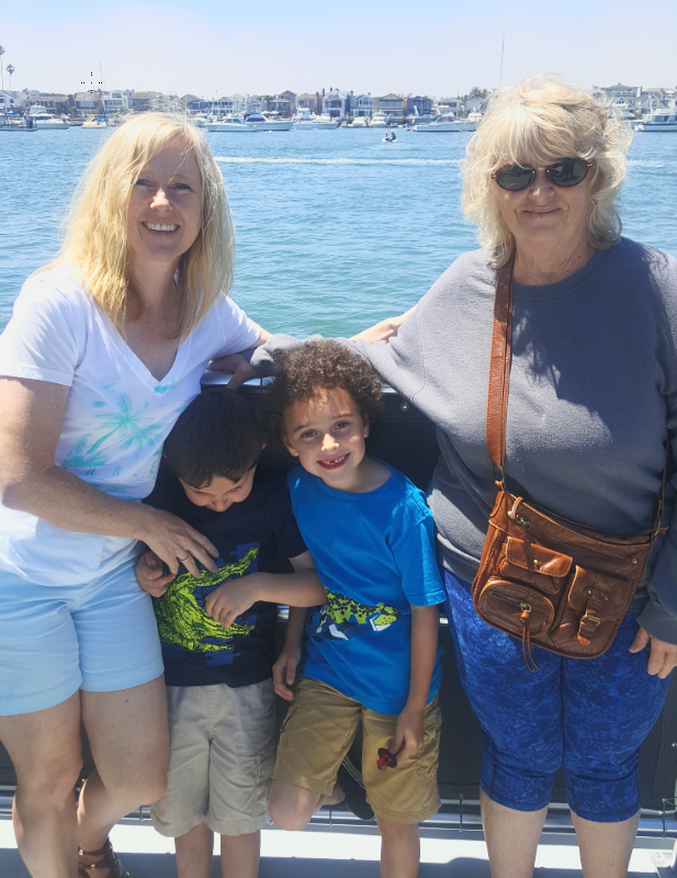 Shari and family together beside the harbor